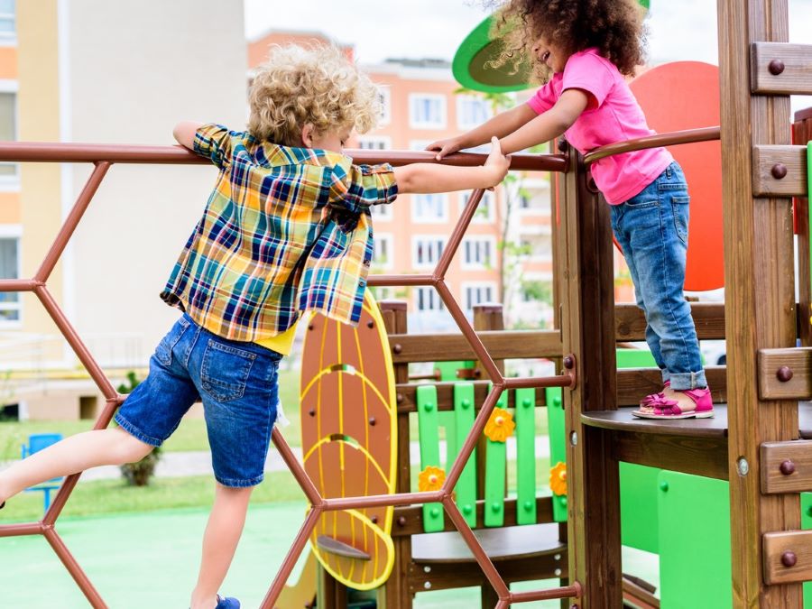 Children playing on a jungle gym.