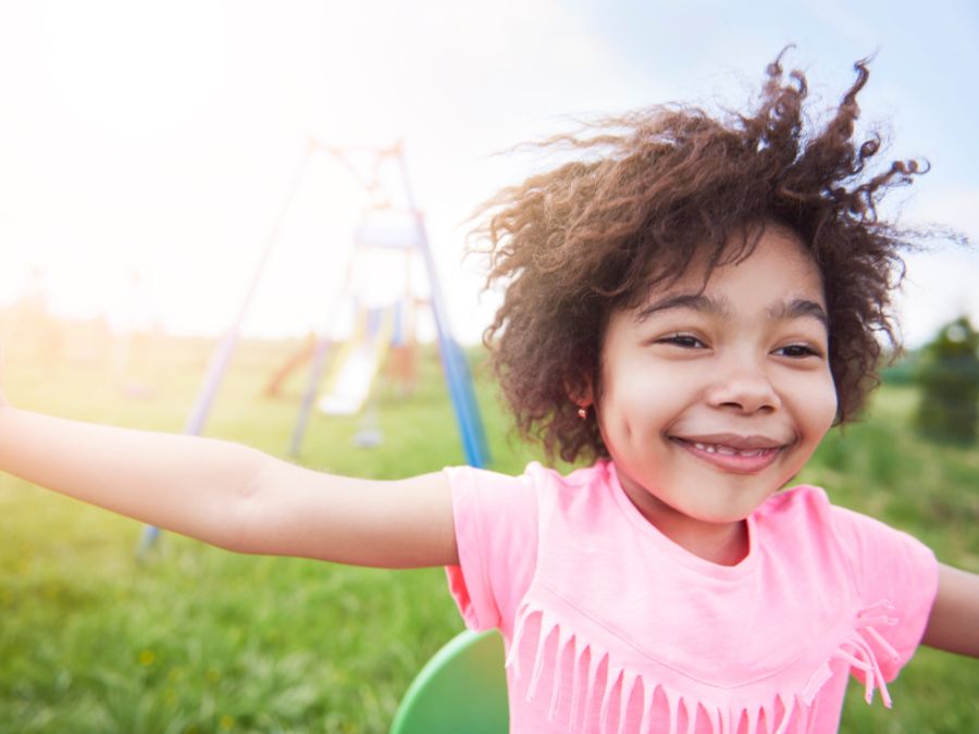 Young girl playing at a play ground.