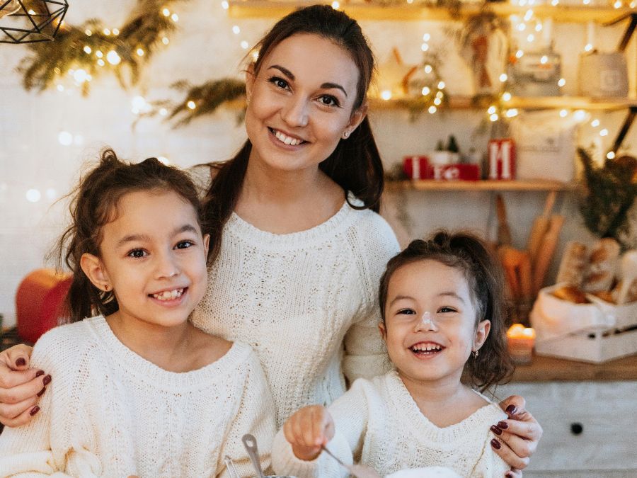 Mother and two daughters cooking
