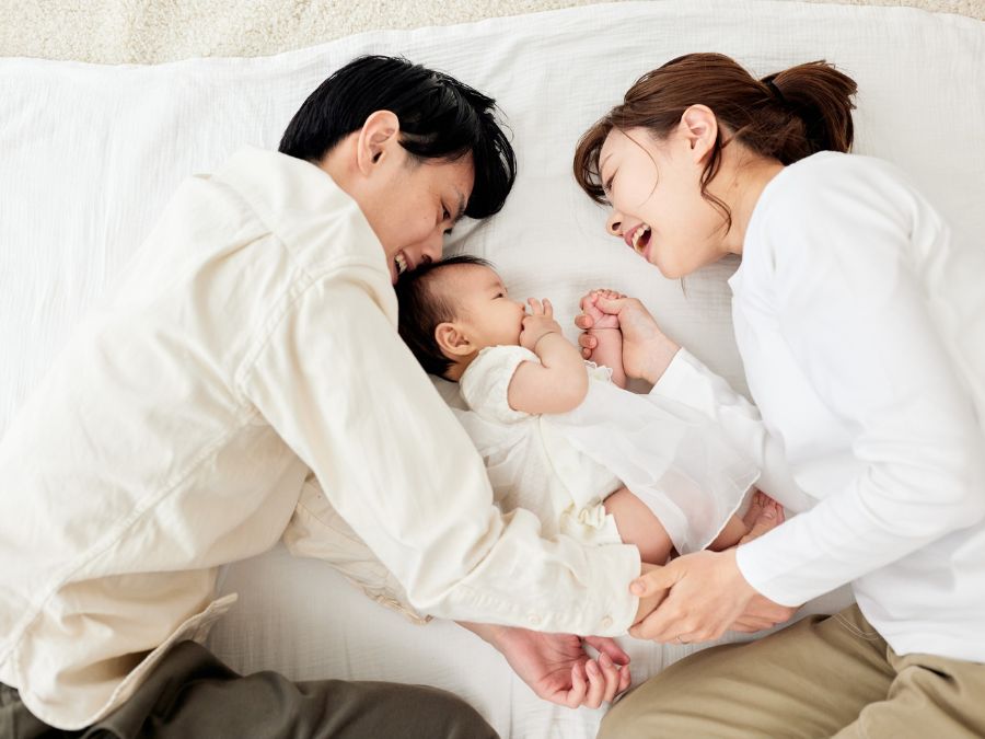 Two parents and their newborn.