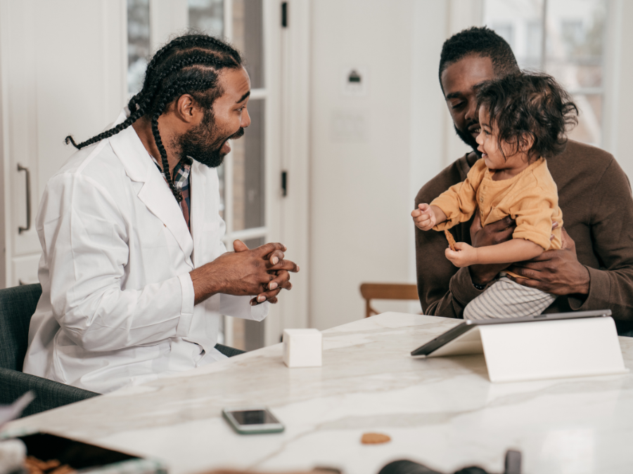 pediatrician talking with father and toddler