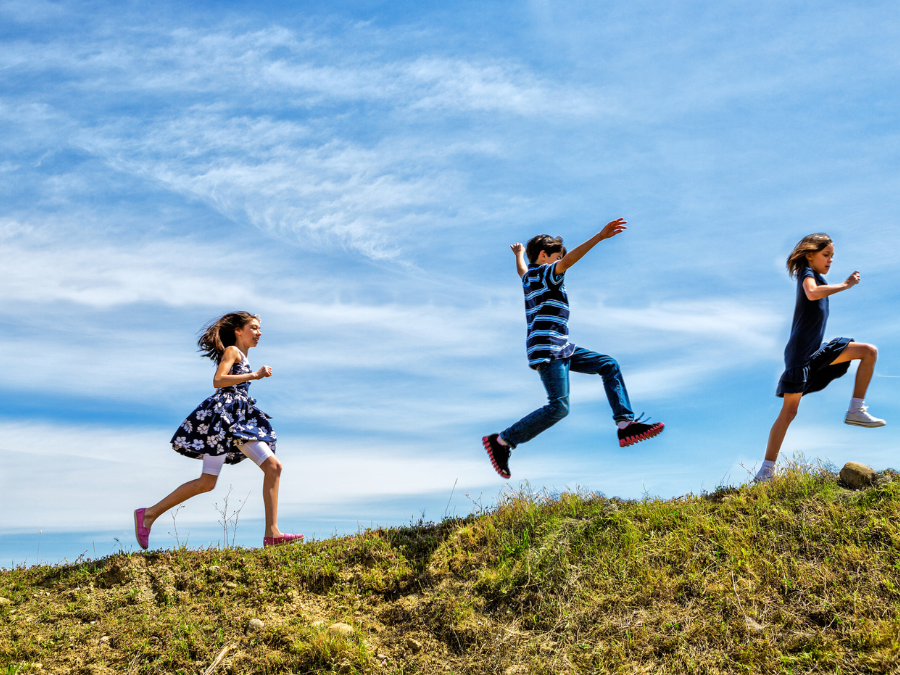 Children running up a hill